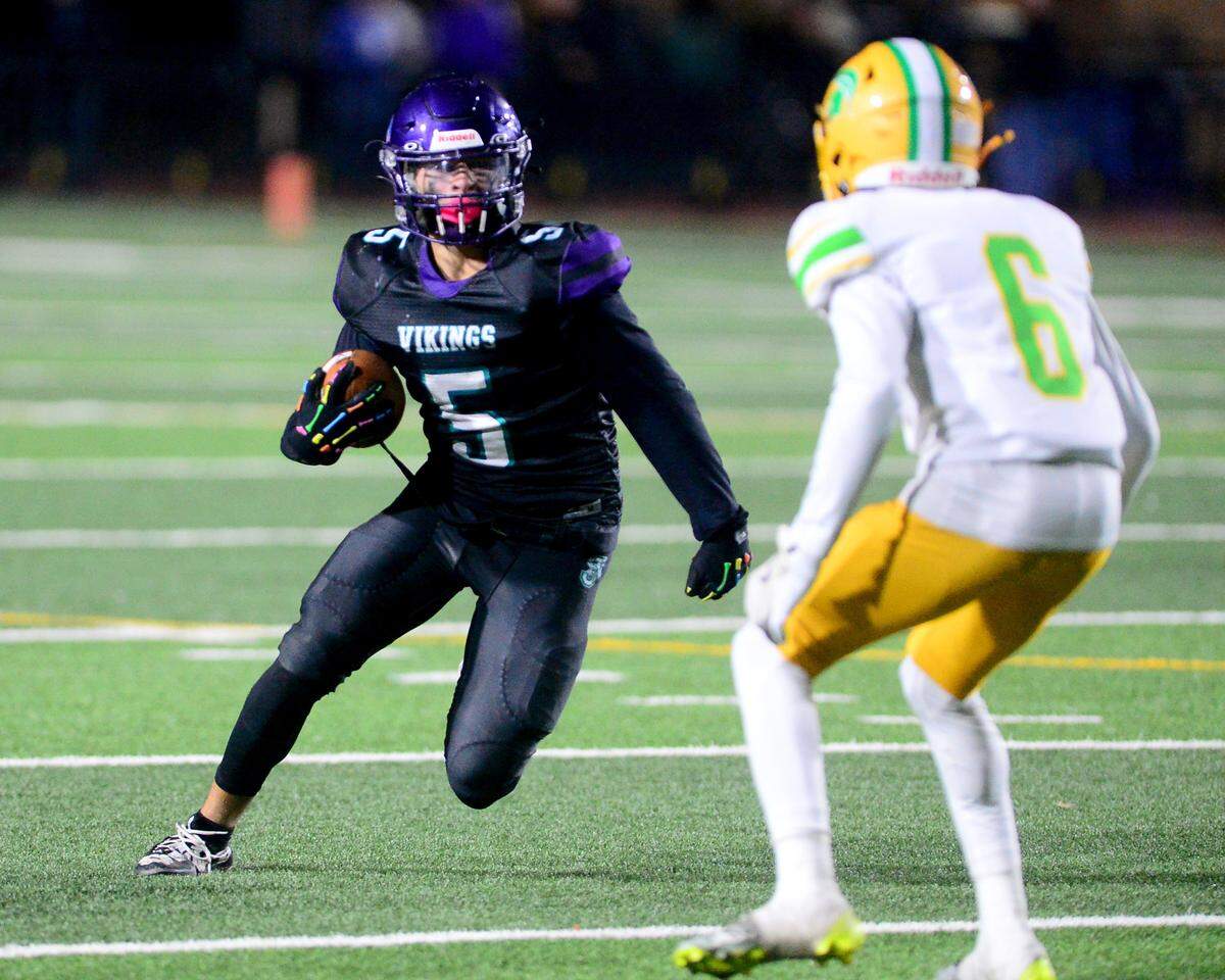 Johansen receiver Grabriel Ibanez (5) eyes a defender after catching a pass in the flat during a game between Johansen and Davis at Johansen High School in Modesto California on November 1, 2024.