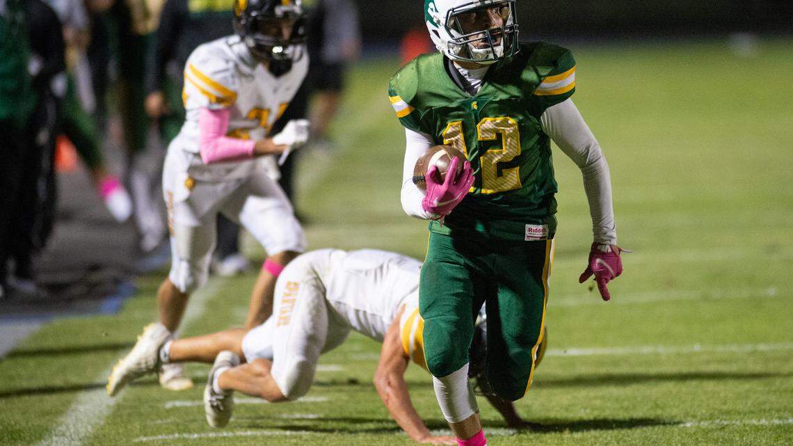 Davis’ Jose Sanchez breaks tackles and runs for a touchdown during the Western Athletic Conference game with Lathrop at Modesto Junior College in Modesto, Calif., on Friday, Oct. 8, 2021. Davis won the game 25-13.