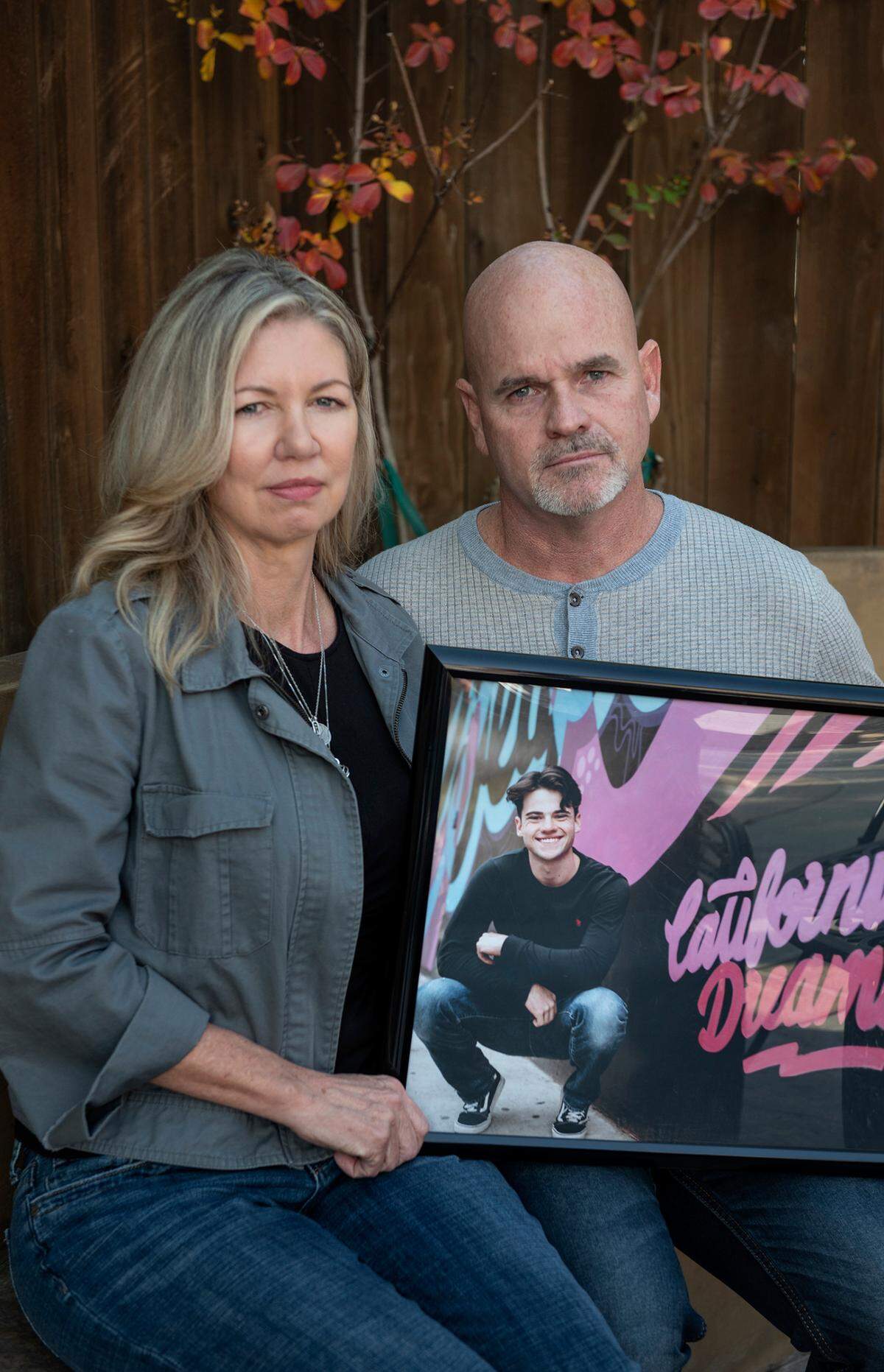 Brandy and Greg Abney hold a picture of their son, Jason, who died of fentanyl poisoning in April. Photographed at their home in Modesto ,Calif., on Wednesday, Nov. 17, 2021.
