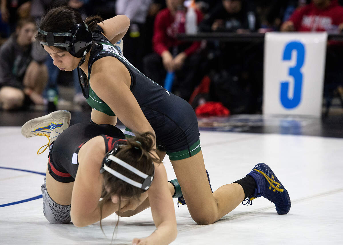 Lilly Avalos of Pitman, right, pinned Laguna Creek’s Isabelle Camarillo at 1:18 to win the 121-pound championship match in the Sac-Joaquin Section Masters wrestling championships at Stockton Arena in Stockton, Calif., Saturday, Feb. 18, 2023.