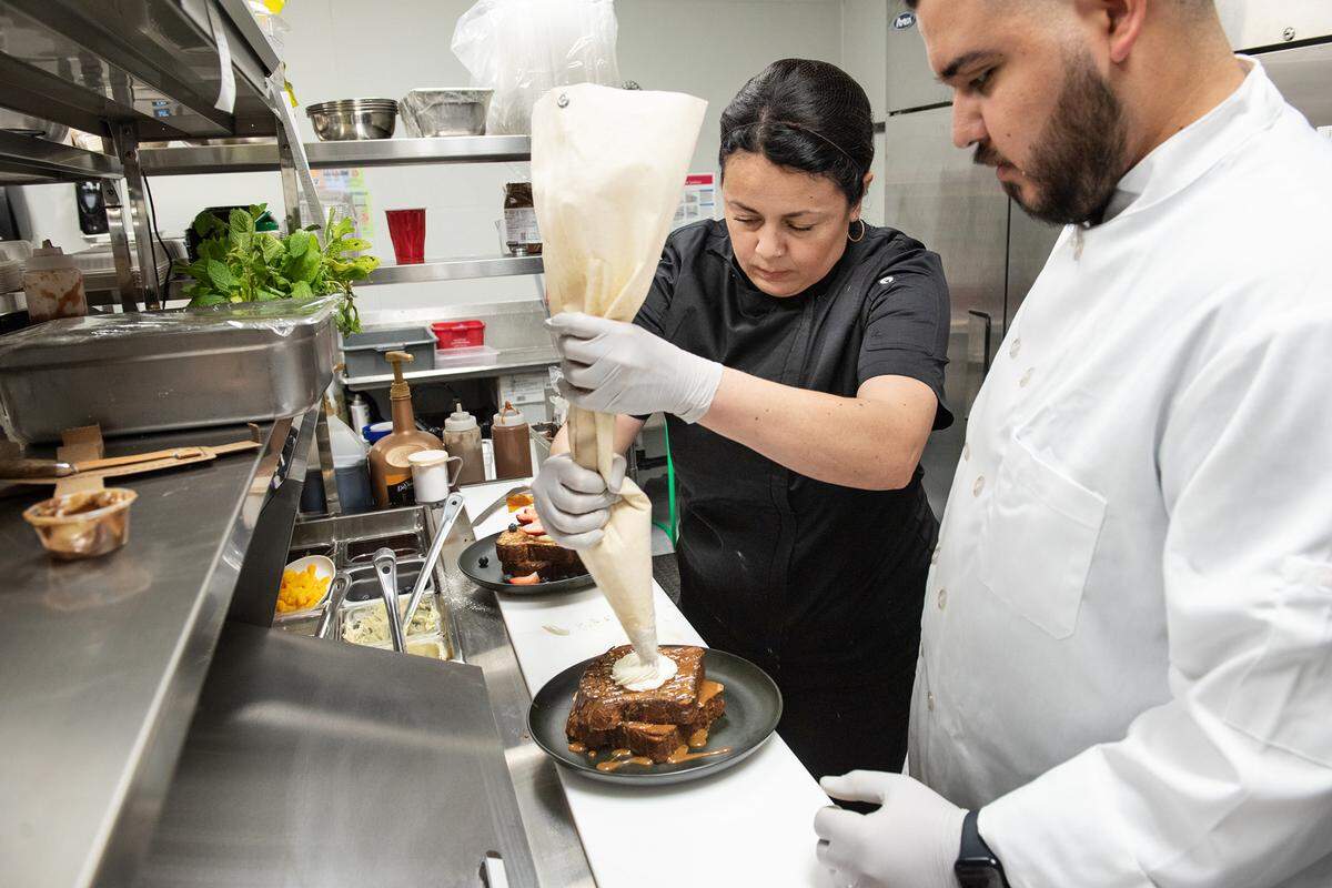 Owner Judith Avila, left, works with chef Aaron Angulo in the kitchen at El Bistro by Salt and Pepper in Modesto, Calif., Thursday, April 13, 2023.