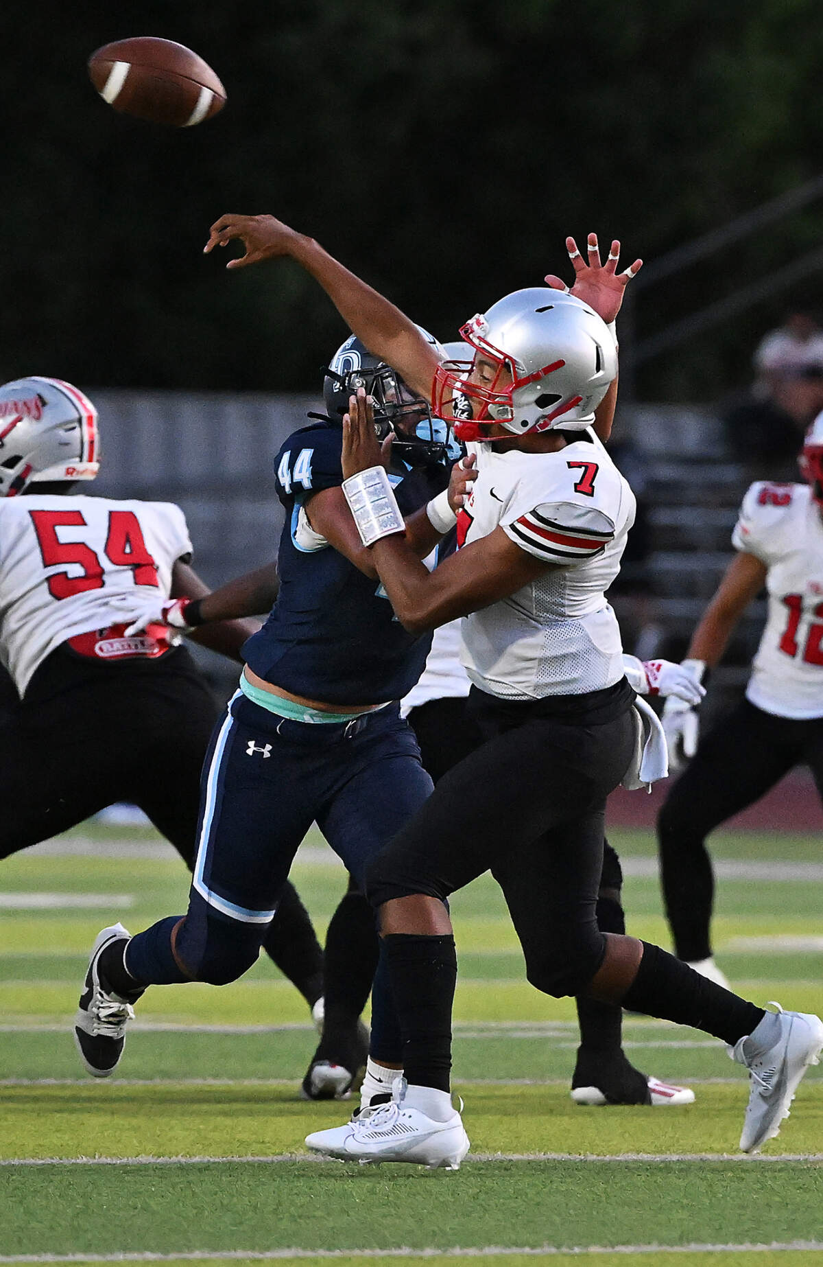 Downey’s Izaiah Quintana pressures Lincoln quarterback Martin Tokmo during the non-league game at Downey High School in Modesto, Calif., Friday, August 18, 2023.