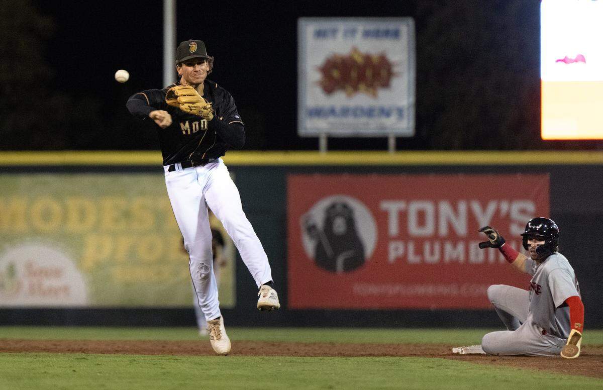 Modesto’s Charlie Pagliarini completes the double play on Lake Elsinore runners during the California League Championship game at John Thurman Field in Modesto, Calif., Wednesday, Sept. 18, 2024.