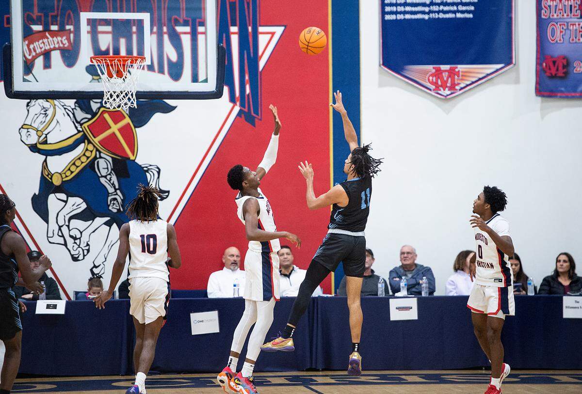 Downey’s Lloyd French attempts a shot Modesto Christian’s as Prince Oseya defends during the Modesto Christian Holiday Hoop Classic in Salida, Calif., Tuesday, Dec. 27, 2022. MC won the game 44-37.