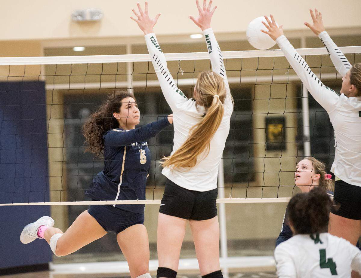 Central Catholic’s Hannah Castillon spikes a ball over the net during the Valley Oak League match with Manteca at Central Catholic High School in Modesto, Calif., on Thursday, Oct. 4, 2018.