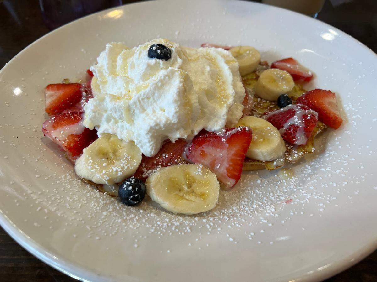 The Concha, an egg-soaked concha bread served with fresh fruit and caramel sauce for $15, at Delicioso Bistro.
