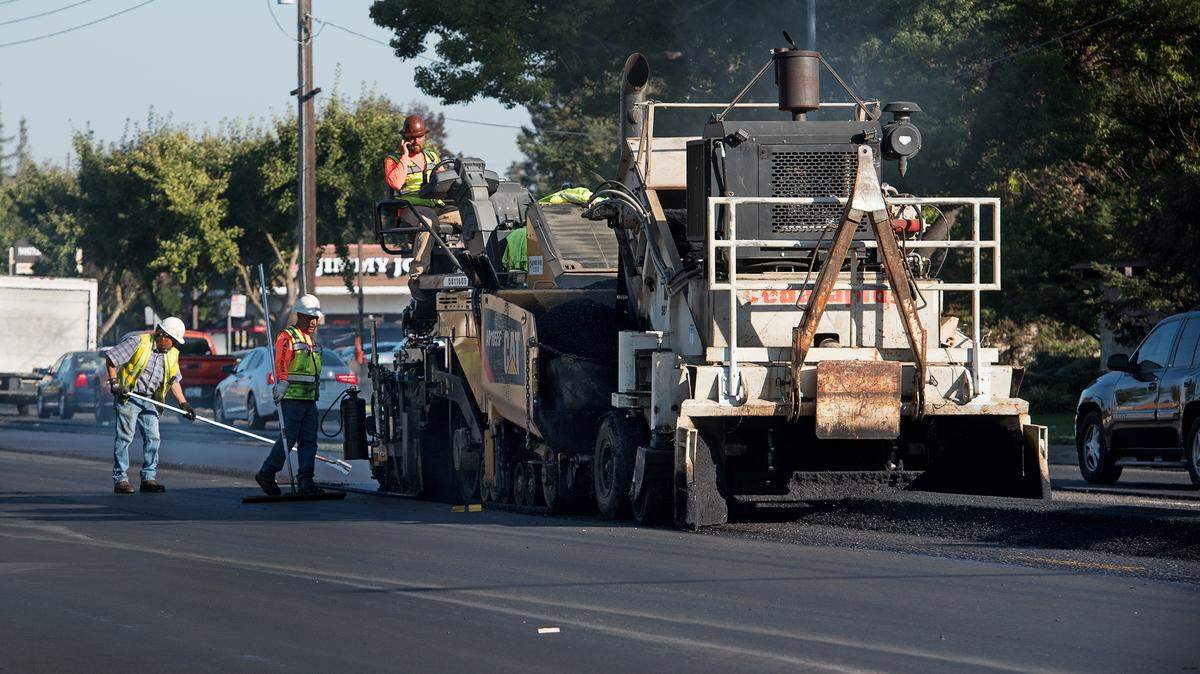 A crew resurfaces Standiford Avenue in Modesto, Ca., on Friday, Oct. 19, 2018.