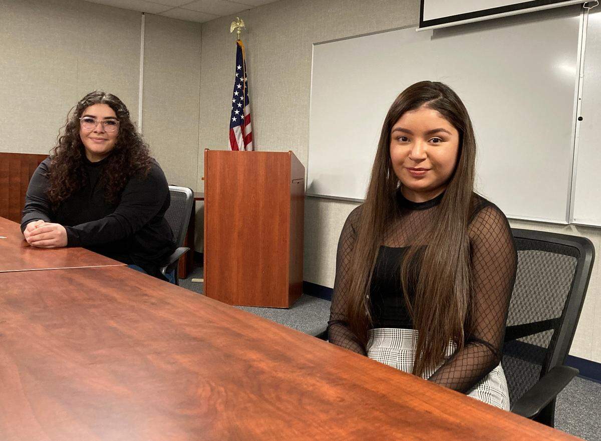 Denair High School seniors, Estefany Flores, 18, and Pureza Avila, 18, discuss the challenges of distant learning during the COVID-19 pandemic at the school district offices in Denair, CA on Feb. 18, 2021
