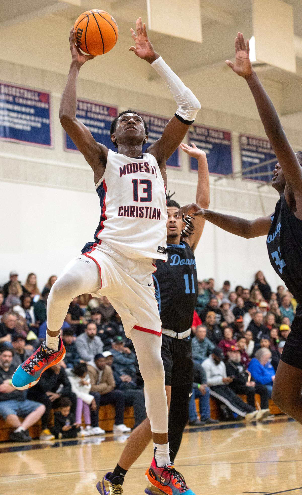 Modesto Christian’s Prince Oseya scores during the Modesto Christian Holiday Hoop Classic game with Downey in Salida, Calif., Tuesday, Dec. 27, 2022.