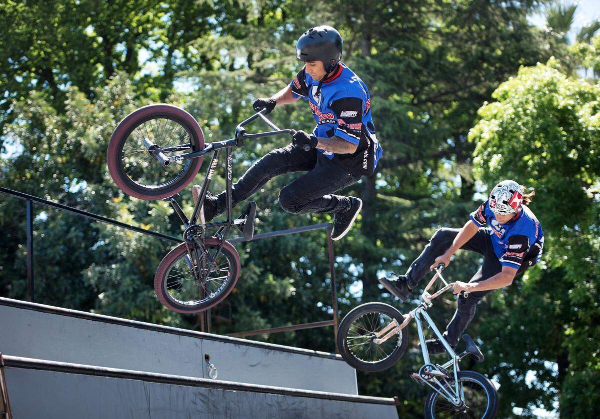 Micheal Mogollon, left and Alex Leo Landeros perform bike tricks during the Modesto Family Cycling Festival in Modesto, Calif., Saturday, May 12, 2018.
