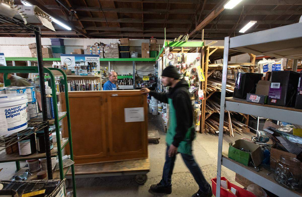 Alex Almaguer helps a customer with a cabinet at  the Habitat for Humanity ReStore in Modesto on April 15, 2022. 