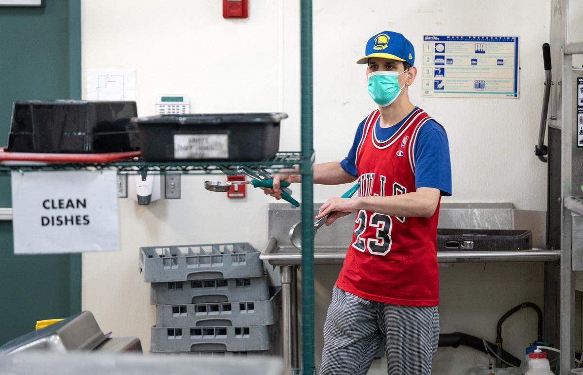 DJ Yarbrough works in the kitchen doing dishes and other cleaning tasks at Howard Prep in Ceres, Calif., Wednesday, Feb. 22, 2023.