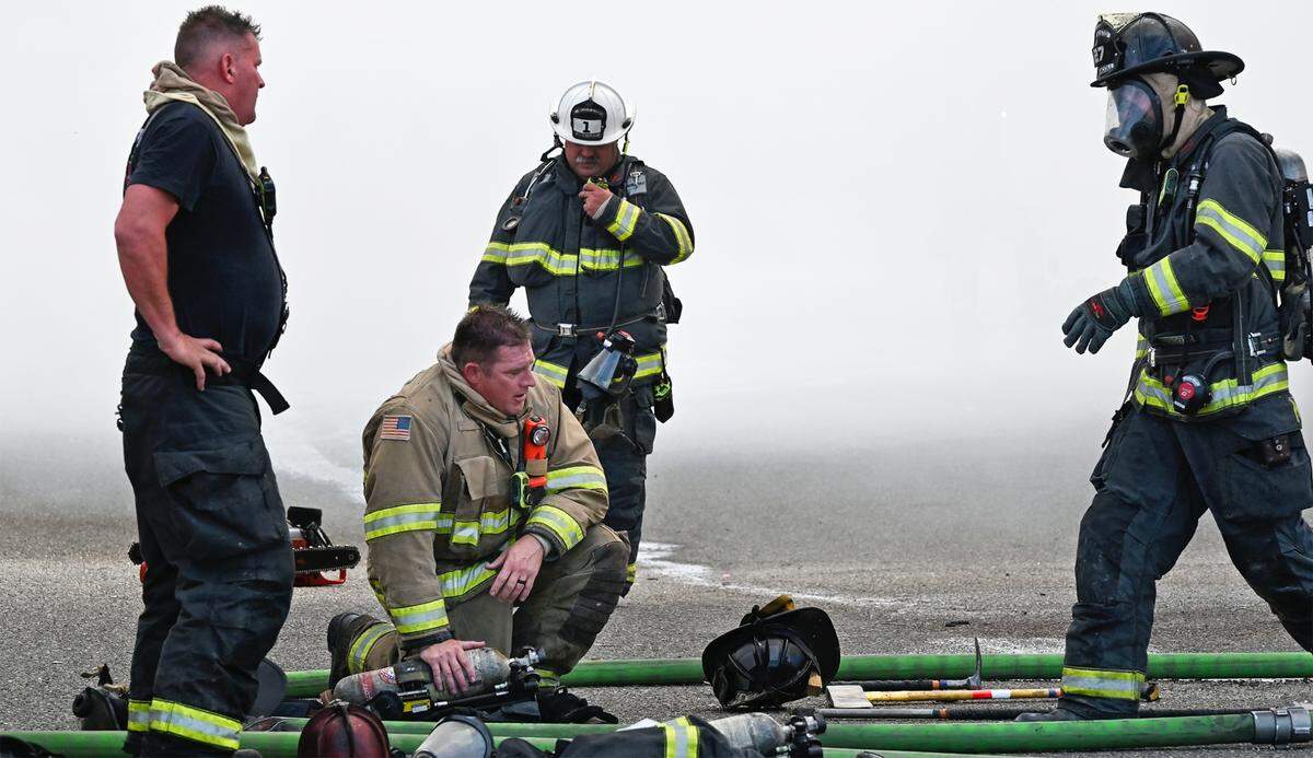 Firefighters recover after fighting a blaze at The Salvation Army Family Thrift Store and Donation Center on McHenry Avenue at Bangs Avenue in Modesto, Calif., on Thursday, June 2, 2022.