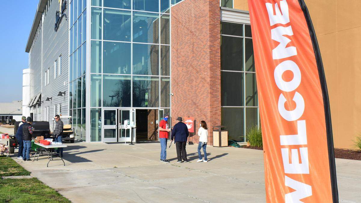 At Coffee Road’s Shelter Cove Community Church on Feb. 7, 2021, in Modesto, Super Bowl Sunday hot dogs are grilled for worshipers and a greeter has masks for anyone who didn’t arrive with one.