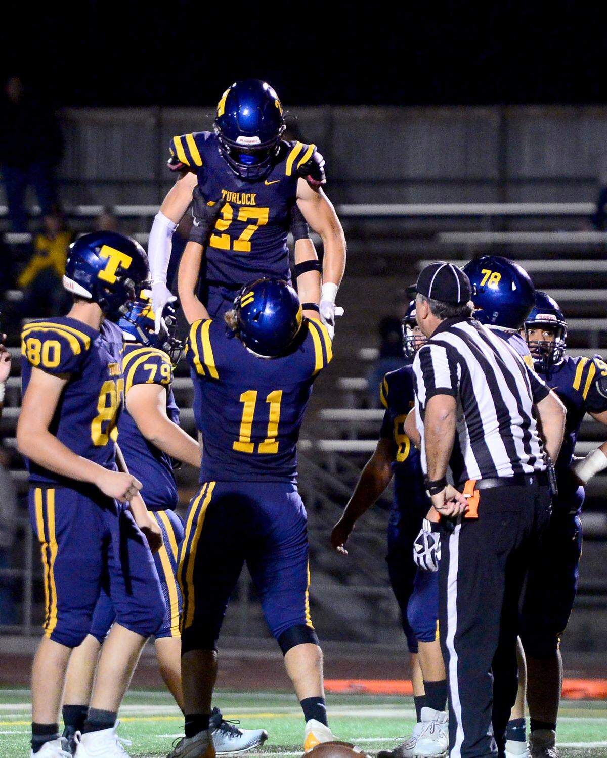 Turlock High’s Brady Green (27) celebrates with Logan Durkee (11) after Green’s touchdown during a CIF Sac-Joaquin Section Football Division I playoff game between Turlock High School and Sheldon High School at Turlock High School in Turlock, California on Nov. 3, 2023.