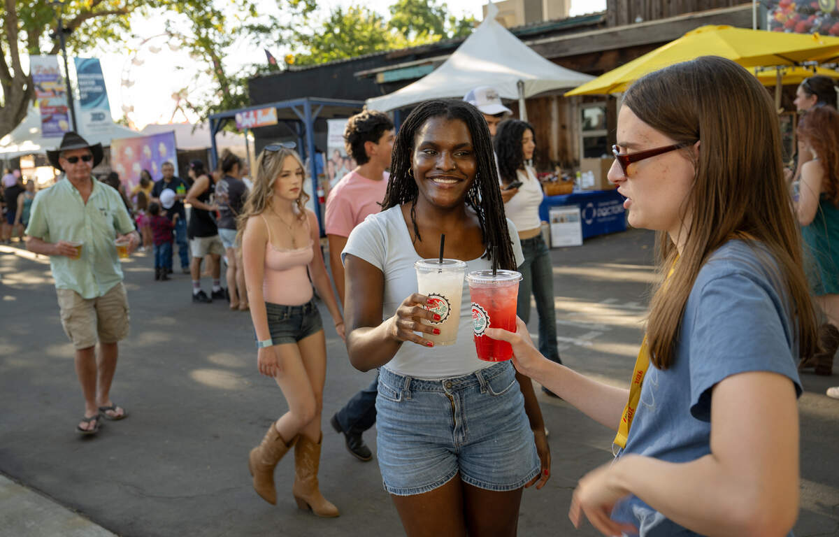 Modesto Bee interns Raina Dent, left, and Bella Waters enjoy a Suds & Floats drink at the Stanislaus County Fair in Turlock, Thursday, July 16, 2026.