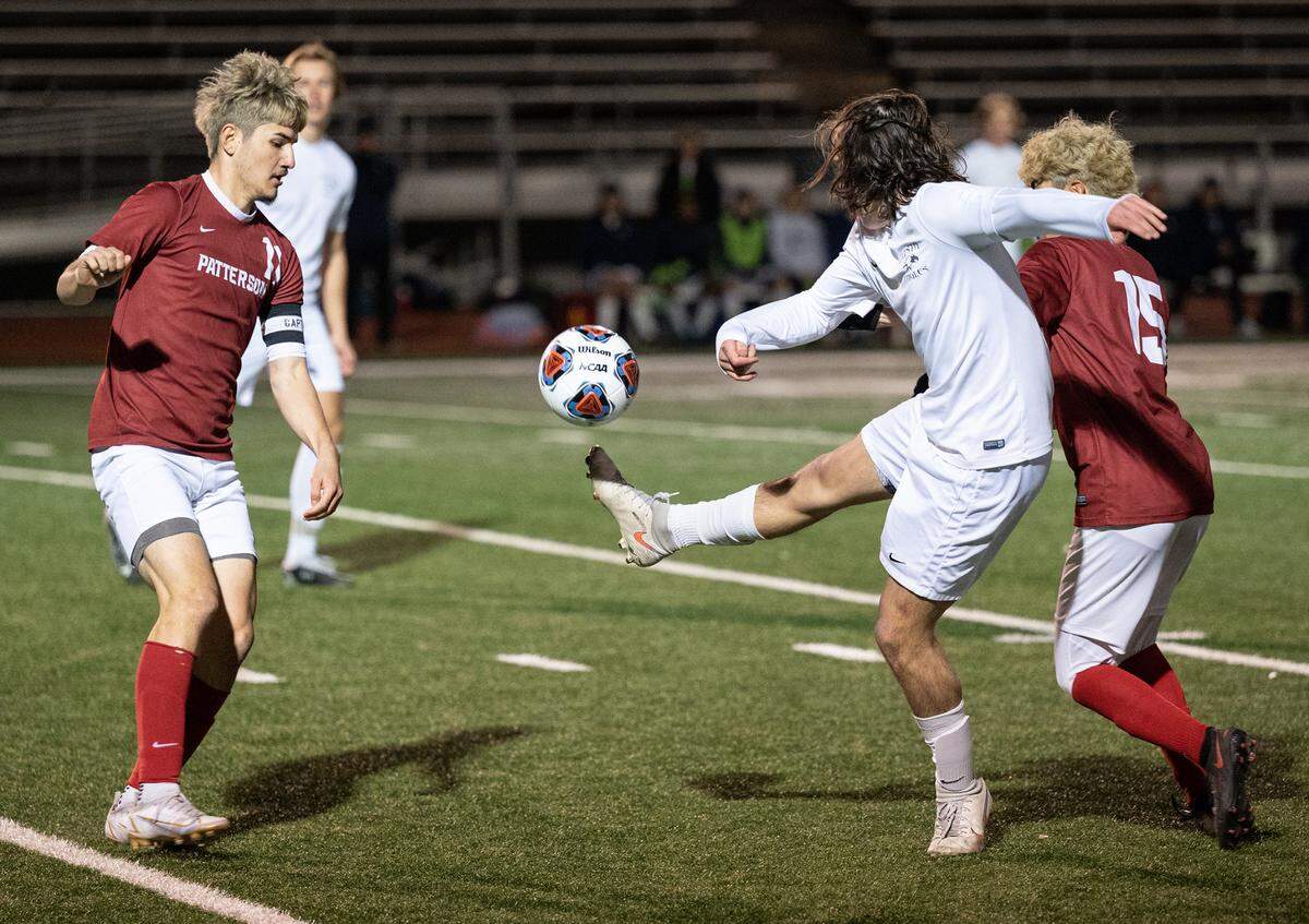 Patterson’s Antonio Gallegos, left, and Luis Castro, right, pressure Vista del Lago’s Elijah Zackney defender in the Sac-Joaquin Section Division III title game at Turlock High School in Turlock, Calif., on Tuesday, Feb. 22, 2022. Vista del Lago won the championship 2-0.