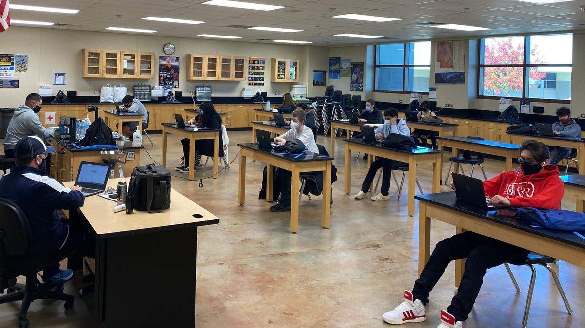 Gregori High students attend school in a learning hub, receiving instruction from their teacher online but with paraprofessionals providing classroom supervision.