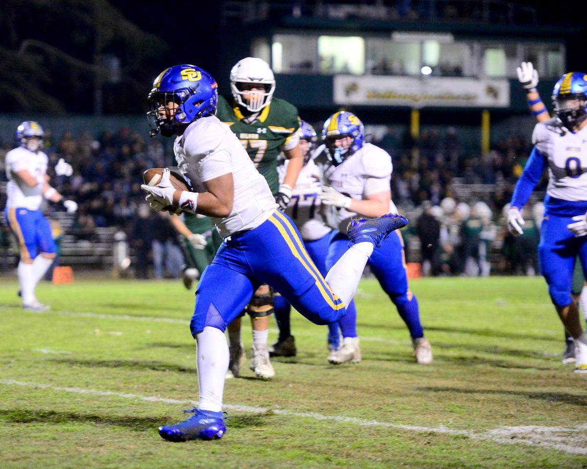 Sutter Huskies running back Losi Asiata (2) runs into the end zone to score a touchdown against Hilmar during a Sac-Joaquin Division V semifinal game in Hilmar on Friday.