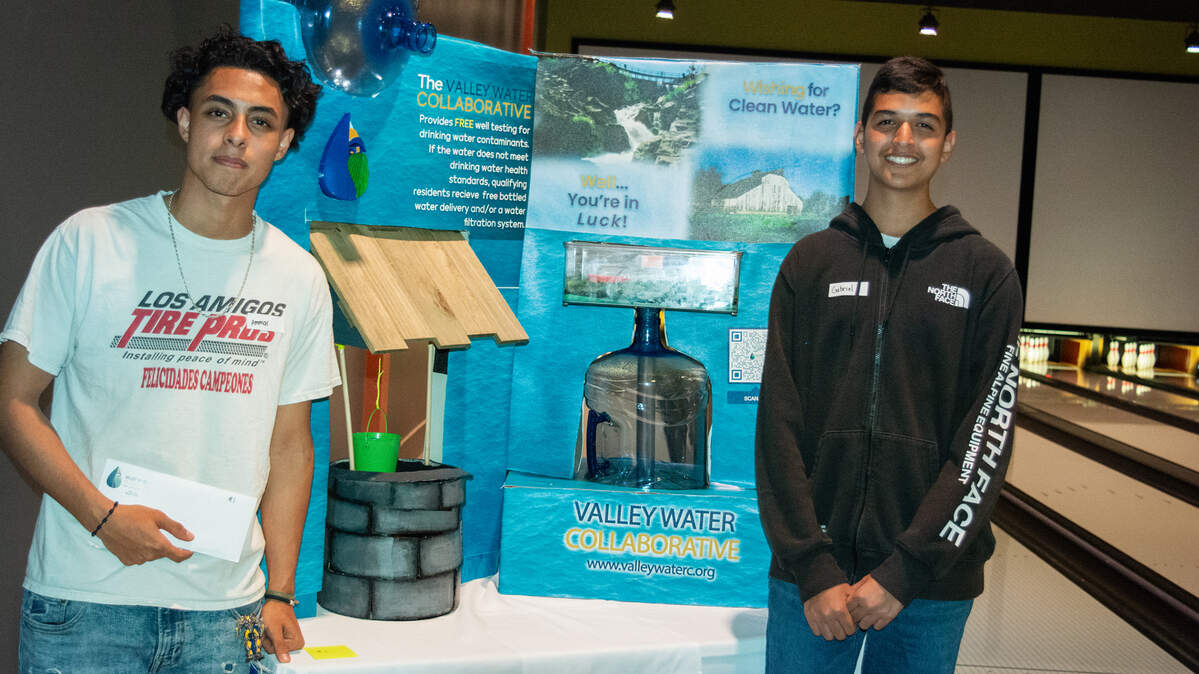 Ammar Salah, left, and Gabriel Davila-Sanchez presented the winning entry among high school teams designing displays for a program that provides free bottled water to homes with polluted wells. They were judged in Turlock CA on May 5, 2022.