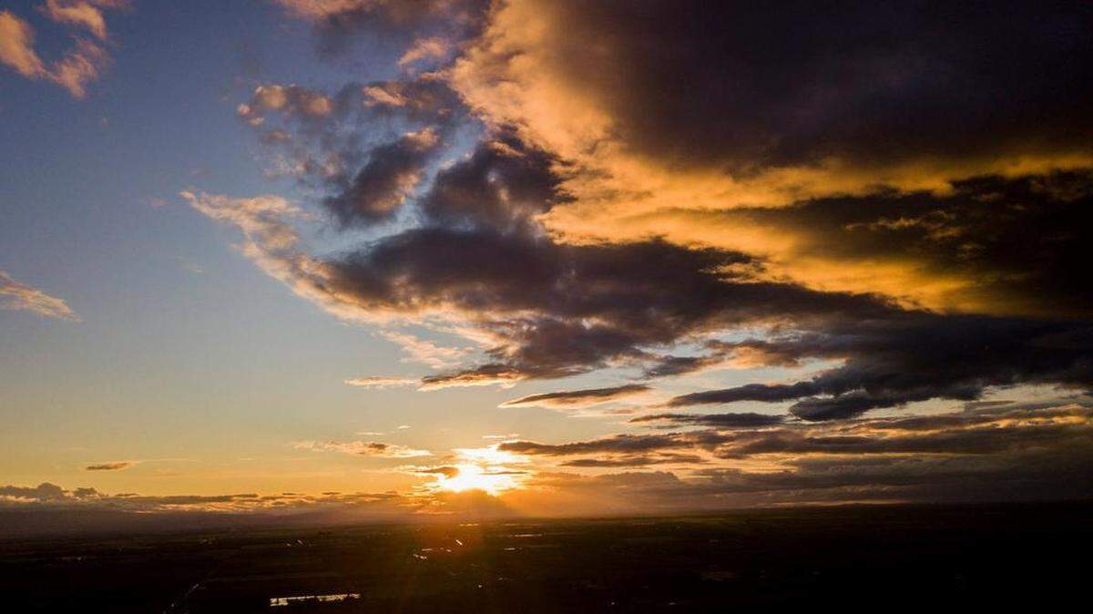 The sun set over western Stanislaus County in April 2018 with the foothills and an overcast sky.