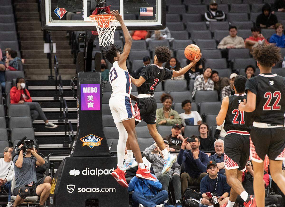 Centennial’s Donovan Dent scores as Modesto Christian’s Driven Johnson defends the basket during boys Open Division CIF State Basketball Championship game at Golden 1 Center in Sacramento, Calif., on Saturday, March 12, 2022. Centennial won the game 59-50.