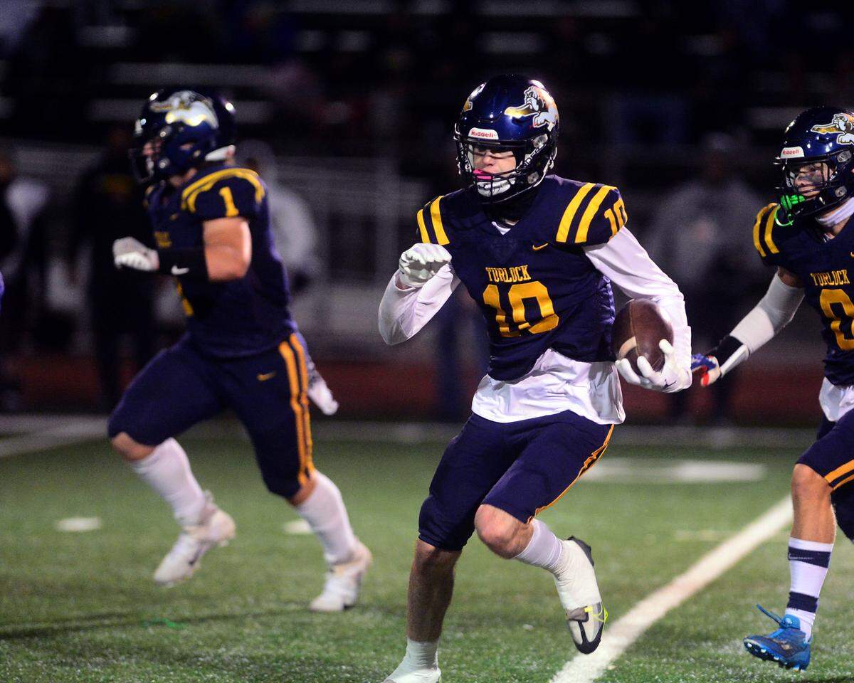 Turlock defensive back Andrew Johnson (10) returns an interception during a CIF Division I CIF Sac-Joaquin Section Football Playoff game between Turlock High School and Edison High School at Turlock High School in Turlock CA on November 4, 2022. Turlock won 35-0.