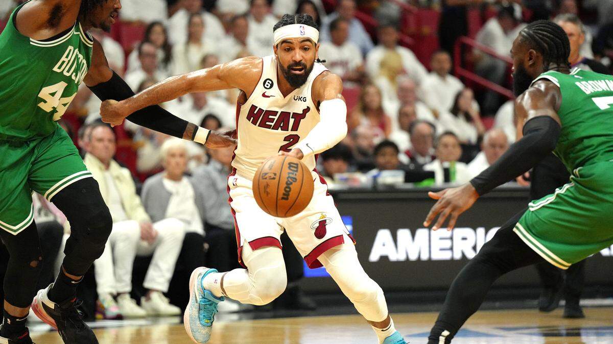 May 23, 2023; Miami, Florida, USA; Miami Heat guard Gabe Vincent (2) controls the ball against Boston Celtics guard Jaylen Brown (7) and center Robert Williams III (44) in the second quarter during game four of the Eastern Conference Finals for the 2023 NBA playoffs at Kaseya Center. Mandatory Credit: Jim Rassol-USA TODAY Sports