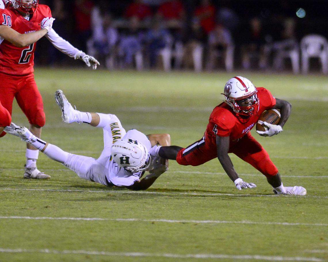 Ripon running back Roland Davis (4) gets taken down by a Hilmar defender during a game between Ripon and Hilmar at Ripon High School in Ripon CA on September 14, 2018.