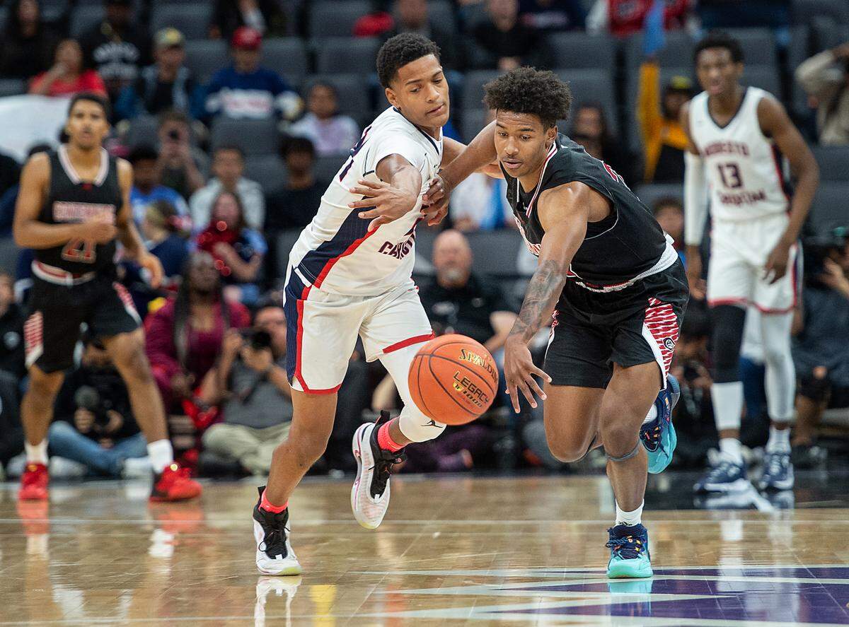 Modesto Christian’s Jamari Phillips and Centennial’s Ramsey Huff chase down a loose ball during the boys Open Division CIF State Basketball Championship game with Centennial at Golden 1 Center in Sacramento, Calif., on Saturday, March 12, 2022. Centennial won the game 59-50.