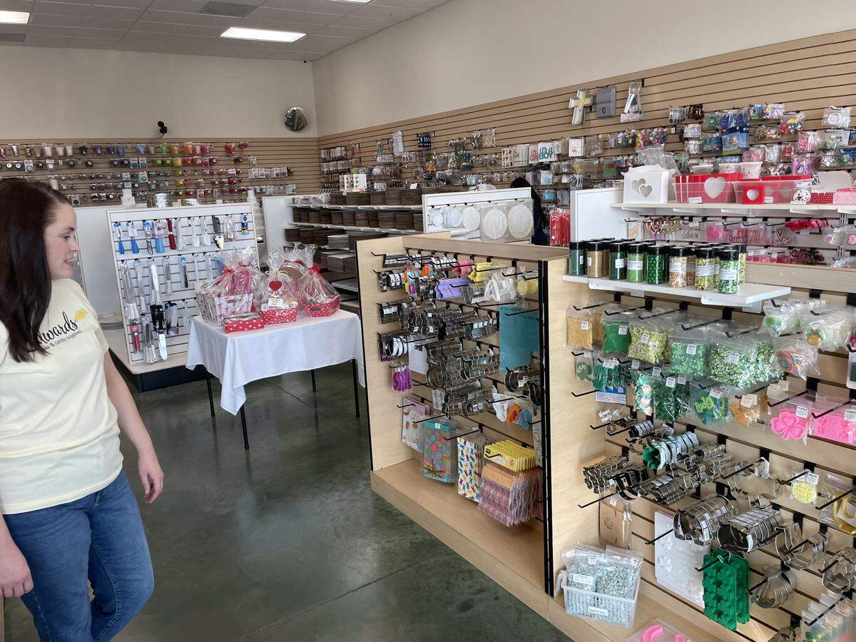 April Brown with a wall of sprinkles and baking decor at Edwards Cake and Candy Supplies on Thursday, Feb. 5 in Modesto.