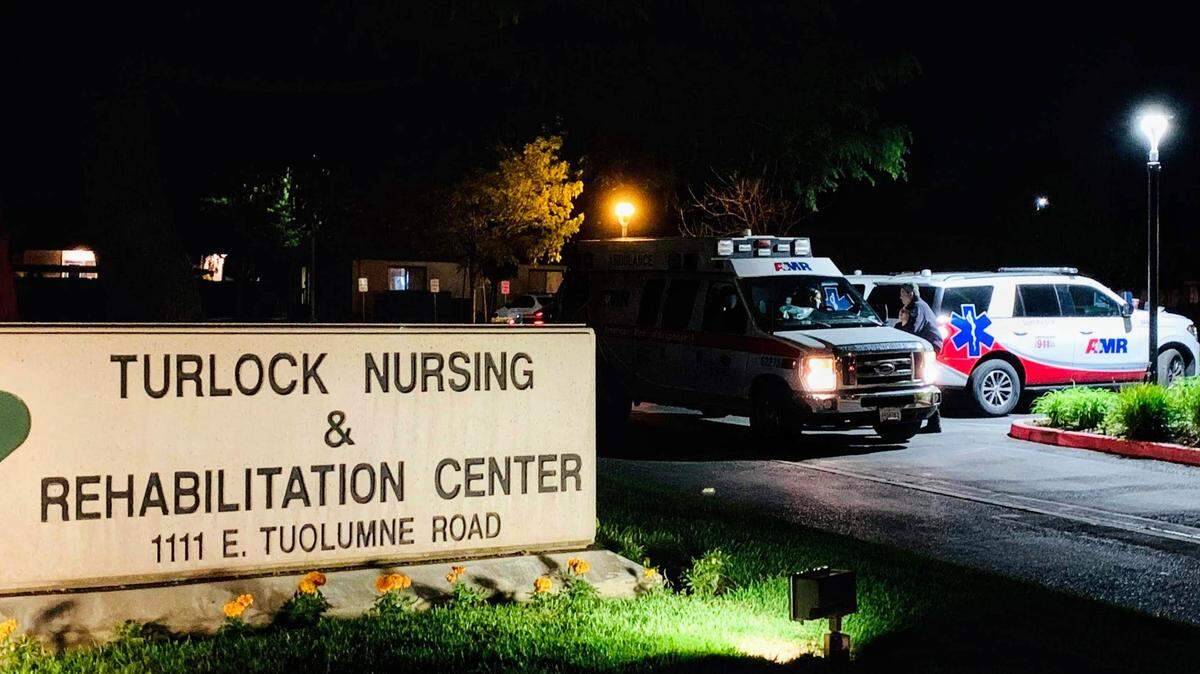 Ambulances wait outside the Turlock Nursing and Rehabilitation Center on Friday, April 24, 2020. Several employees and patients tested positive For COVID-19, according to the care facility in California.
