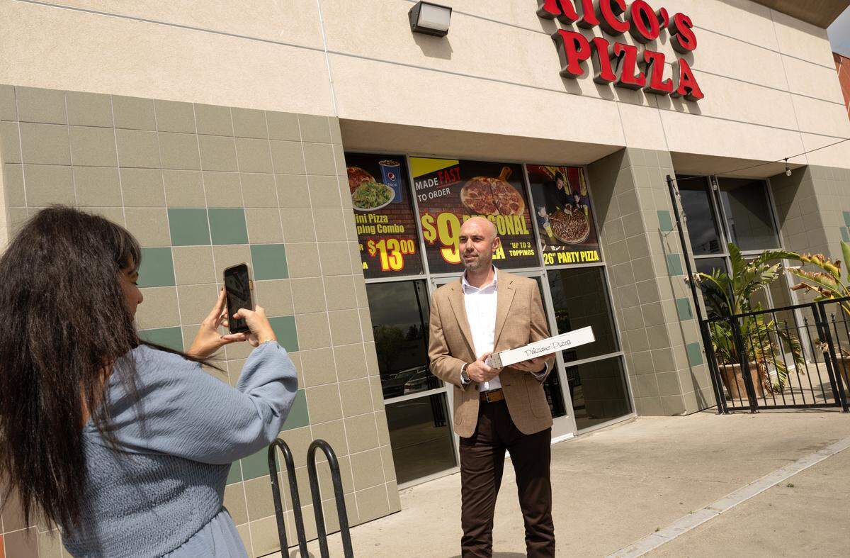 Reviewer Damien Wilson samples the pizza at Rico’s Pizza in Turlock, Thursday, March 27, 2025.