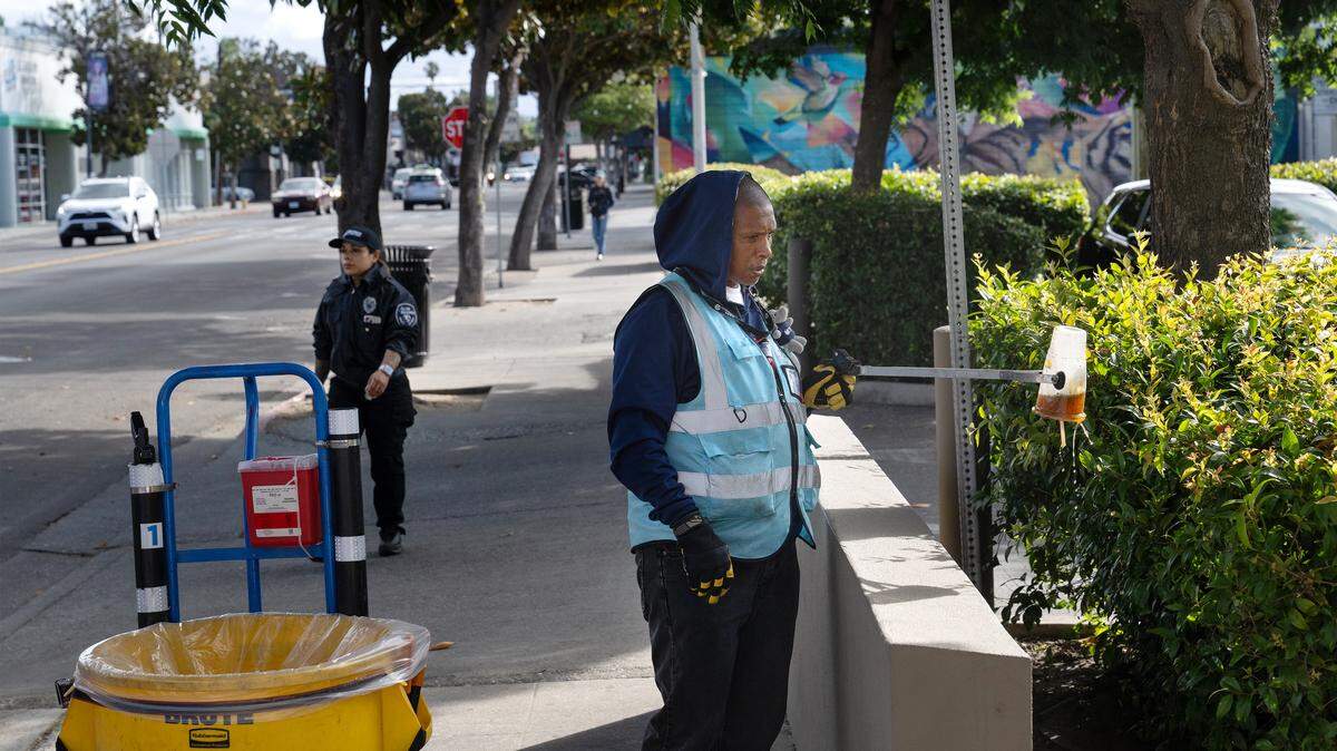 Hope Works program worker Demetrius Elgin picks up garbage thrown into a planter along J Street in Modesto, Tuesday, May 26, 2026. Since its launch in the beginning of the year, the program has removed 20 tons of trash from the streets of Modesto.