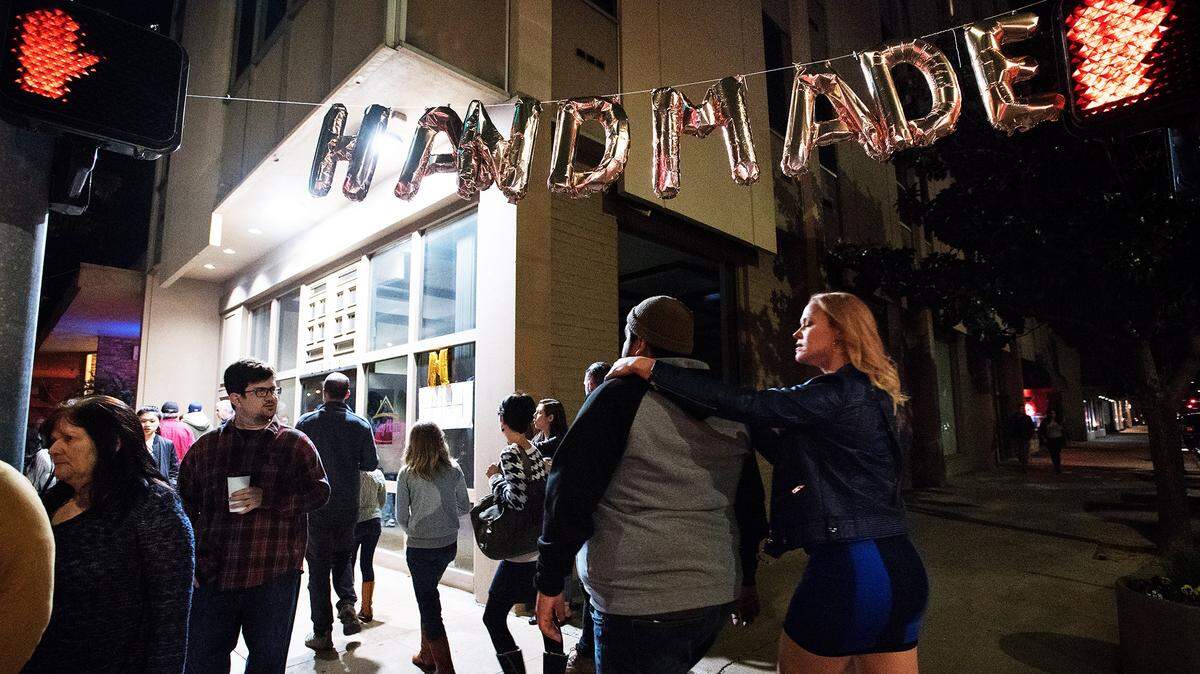 Shoppers walk between pop-up shops to look at artisan goods during the 2018 Mod Shop handmade market in Modesto.