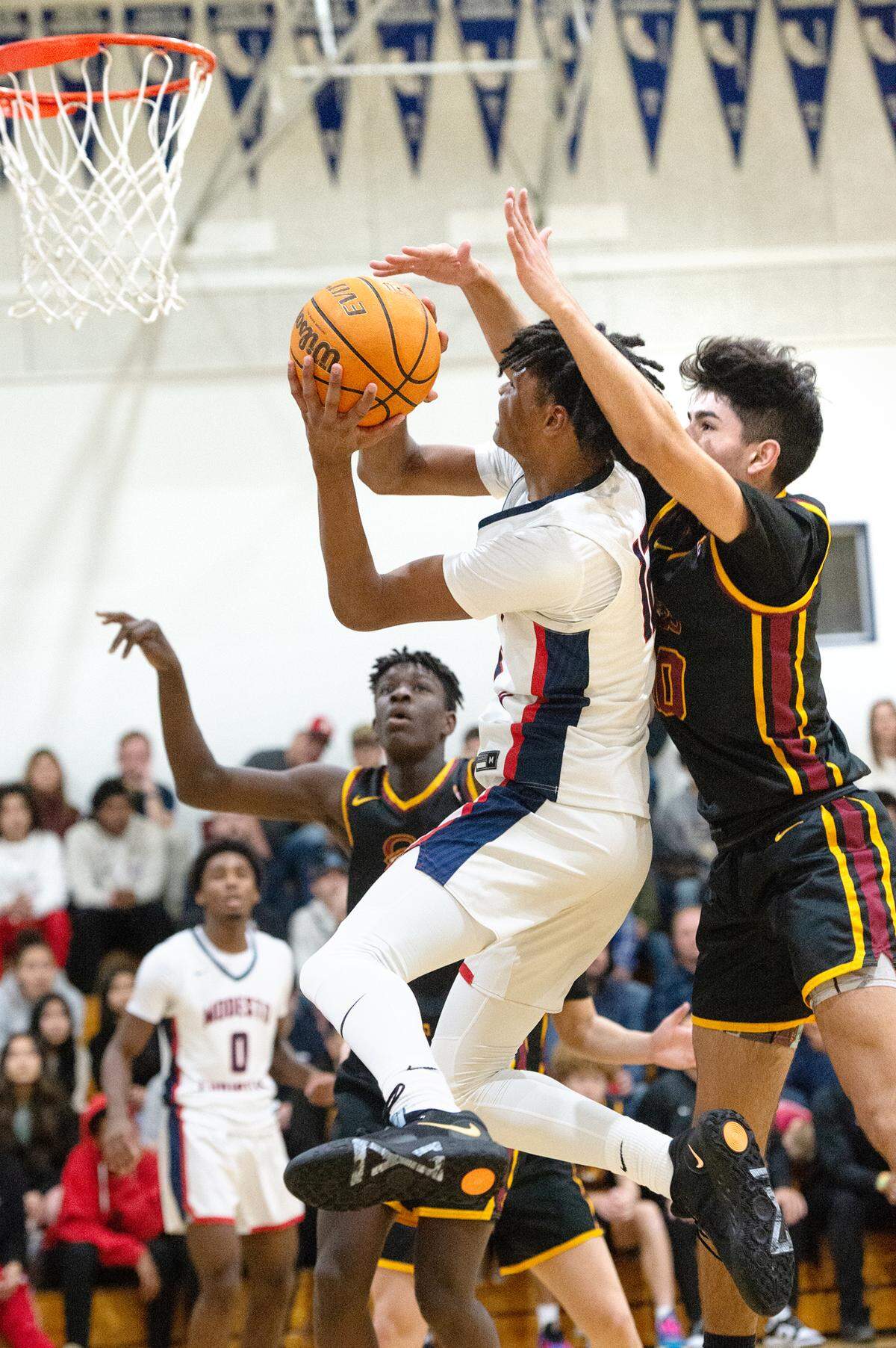 Modesto Christian’s Zeke Davis scores past Clovis West’s Zach Chauhan during the Modesto Christian Holiday Hoop Classic championship game at Modesto Christian High School in Salida, Calif., Friday, Dec. 30, 2022. MC won the game 79-55.