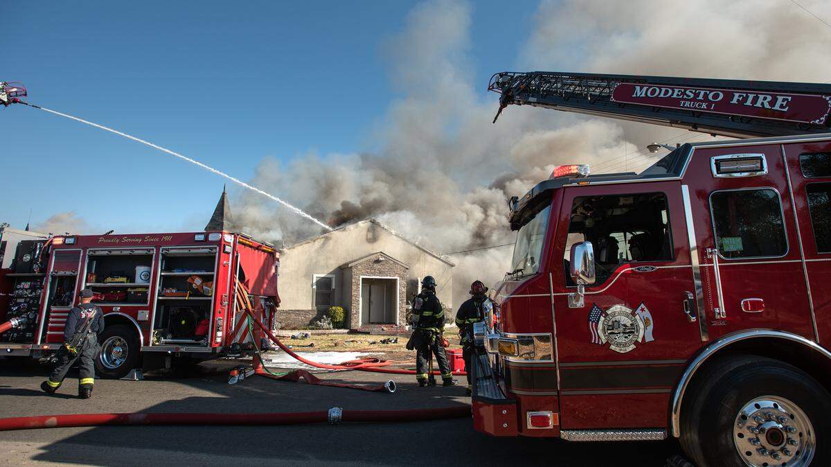In this Oct. 31, 2020 file image, Modesto and Ceres firefighters battle in defensive mode a fire that consumed Apostolic Church in south Modesto, Calif. The Ceres City Council on Monday is set to vote on contracting Modesto for fire services.