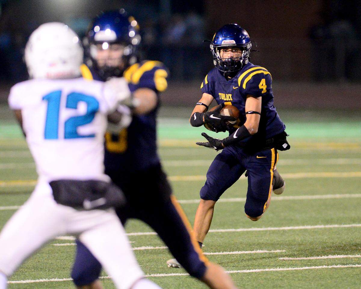 Turlock running back Jr. Silva (4) runs a sweep during a CIF Sac-Joaquin Section Football Division I playoff game between Turlock High School and Sheldon High School at Turlock High School in Turlock, California on Nov. 3, 2023.