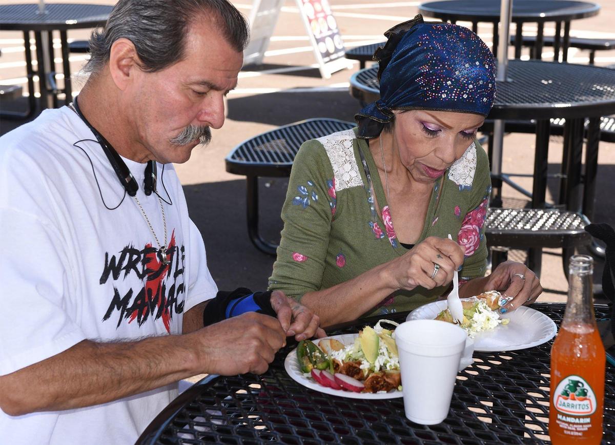 Alfred and Anna Hanks enjoy their food on Wednesday May 1, 2019. Today is the first day of operation for Modesto Grub Hubs, the new food truck court at the corner of Ninth and G streets in downtown Modesto, Calif.