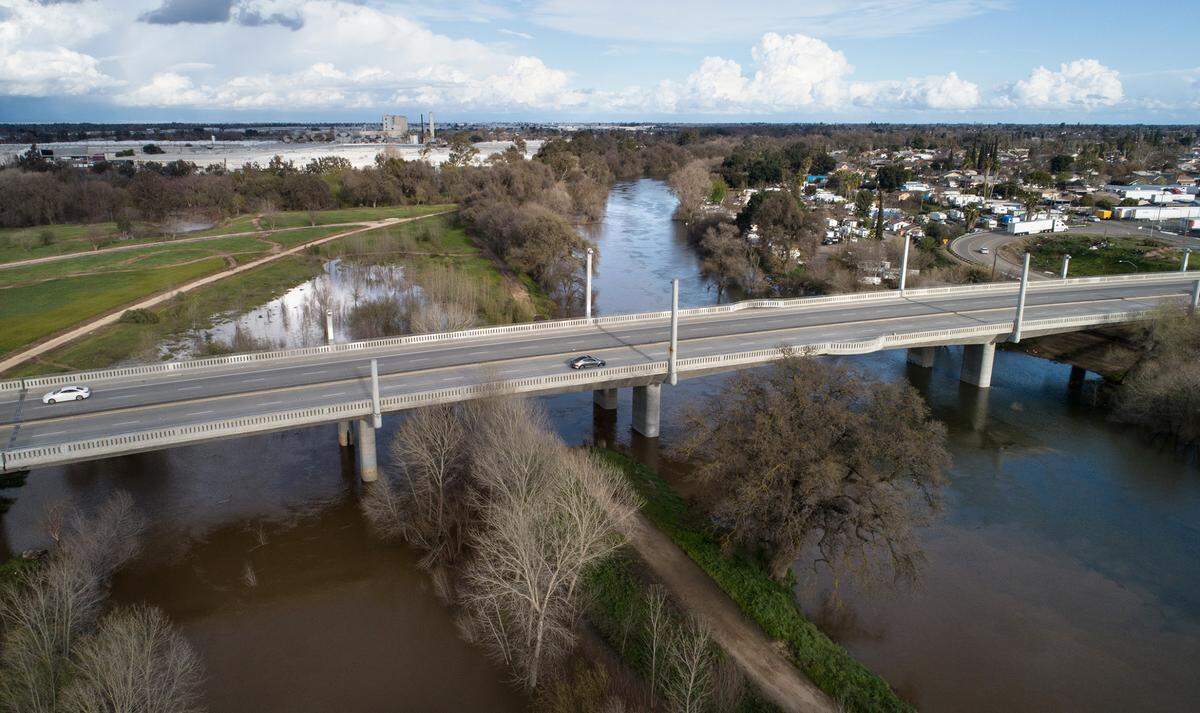The Tuolumne River at the 9th Street Bridge in Modesto, Calif., is pictured Saturday afternoon, March 11, 2023.