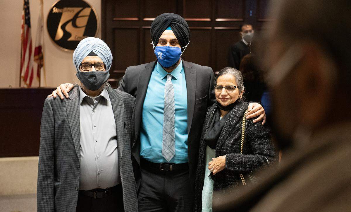 Mani Grewal poses for pictures with his father Gurpal, left, and mother Param after Grewal was officially became a member of the Stanislaus County Board of Supervisors during a swearing-in ceremony in Modesto, Calif., on Wednesday, Nov. 2, 2020.