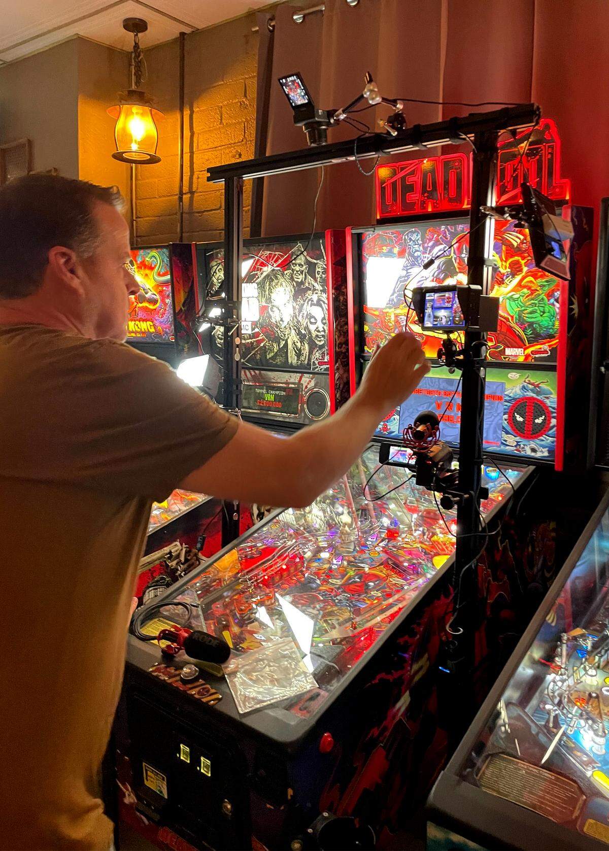 David Stoddard sets up a pinball recording system for viewers on Twitch before a tournament at Contentment Brewing in Modesto, Wednesday, Sept. 24, 2025. 