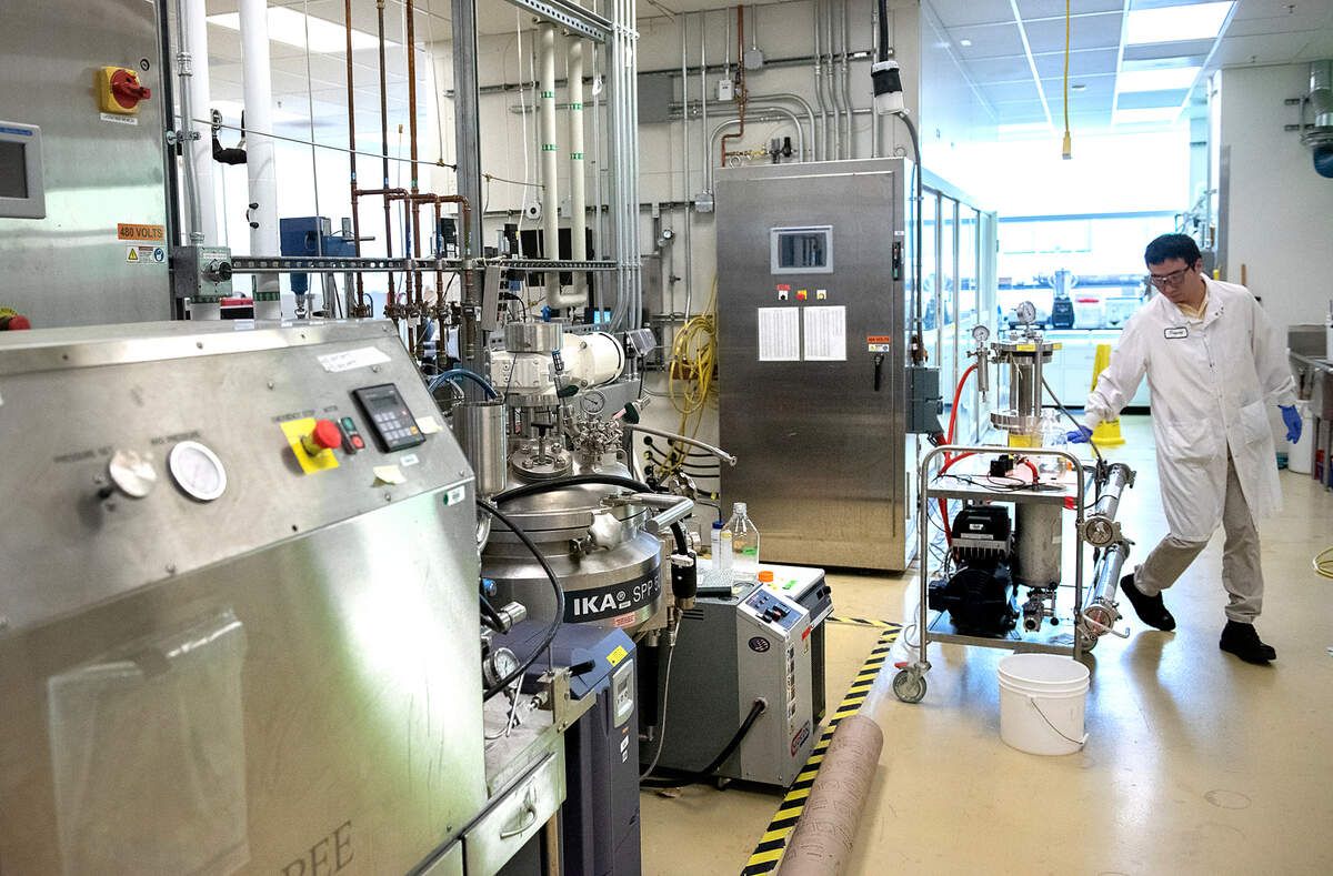 Advanced Biofuels and Bioproducts Process Development Unit (ABPDU) Senior Process Engineer Dupeng Liu filters out lignin from poplar feedstock at the Lawrence Berkeley National Laboratory in Emeryville, Calif., Thursday, Feb. 2, 2023. The ABPDU was established by the United States Department of Energy to help ramp up the bioeconomy.