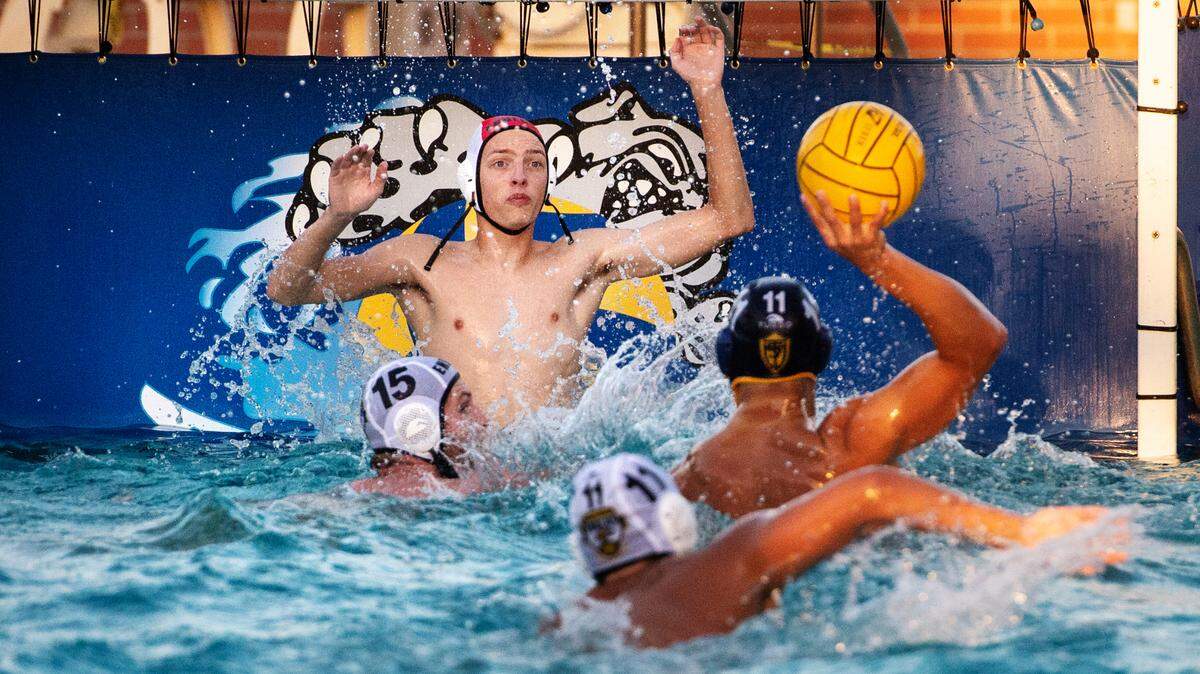 Enochs goalie Cash Harmon rises out of the water to defend a shot on goal from Turlock’s Sean McMillan during a Central California Athletic League match at Turlock High School in Turlock, Calif., on Tuesday, Oct. 12, 2021. Turlock won 20-3.