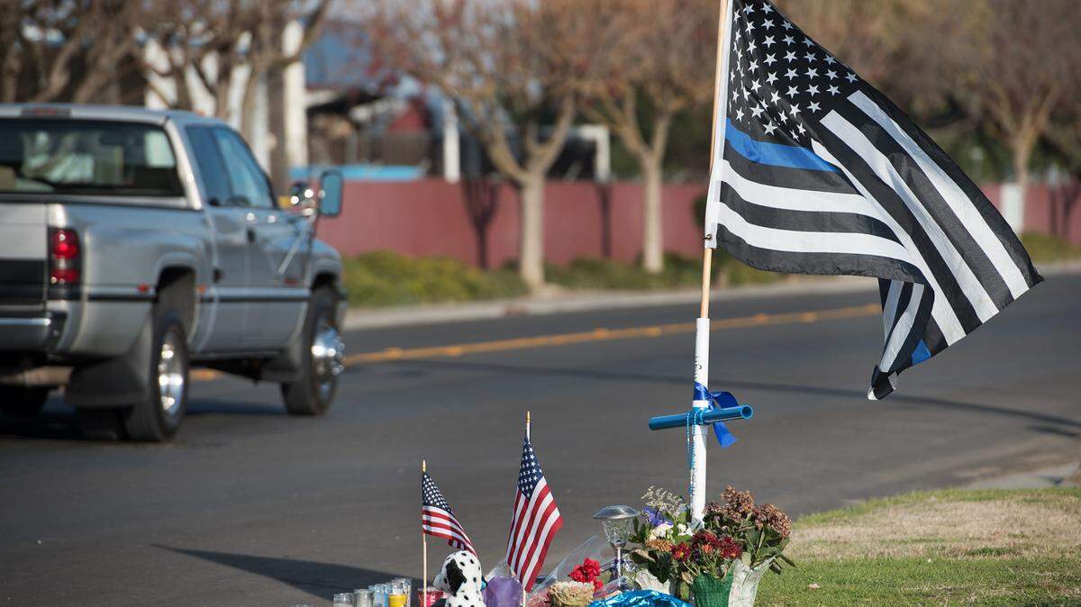 A small memorial have been placed on Merced Street to remember slain officer Ronil Singh in Newman, Calif., Thursday, Jan. 3, 2019.
