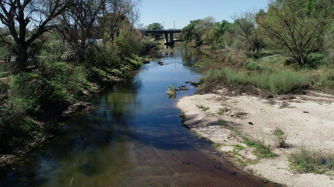 The Tuolumne River near the confluence with Dry Creek and the 9th Street bridge in Modesto, Calif.
