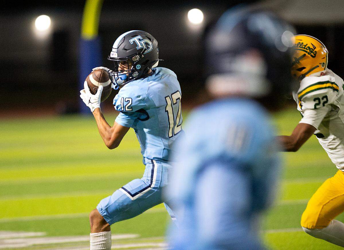 Downey’s Gabe Hernandez makes a reception during the nonleague game with Tracy at Downey High School in Modesto, Calif., on Friday, September 16, 2022.