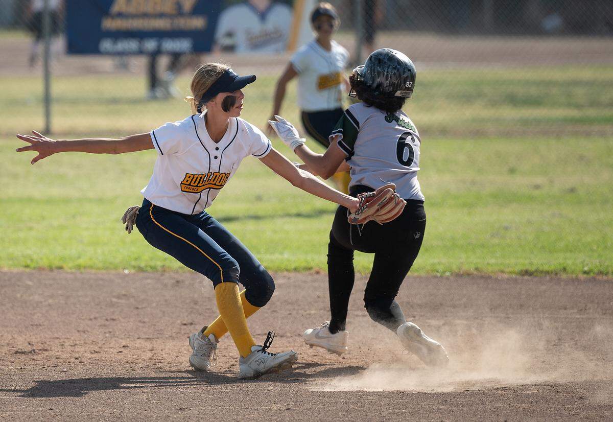 Turlock’s Cadence Campbell tags out Pitman’s Emilie Espinosa on a steal attempt during the Central California Athletic League game at Turlock High School in Turlock, Calif., on Thursday, April 7, 2022. Turlock won the game 8-2.