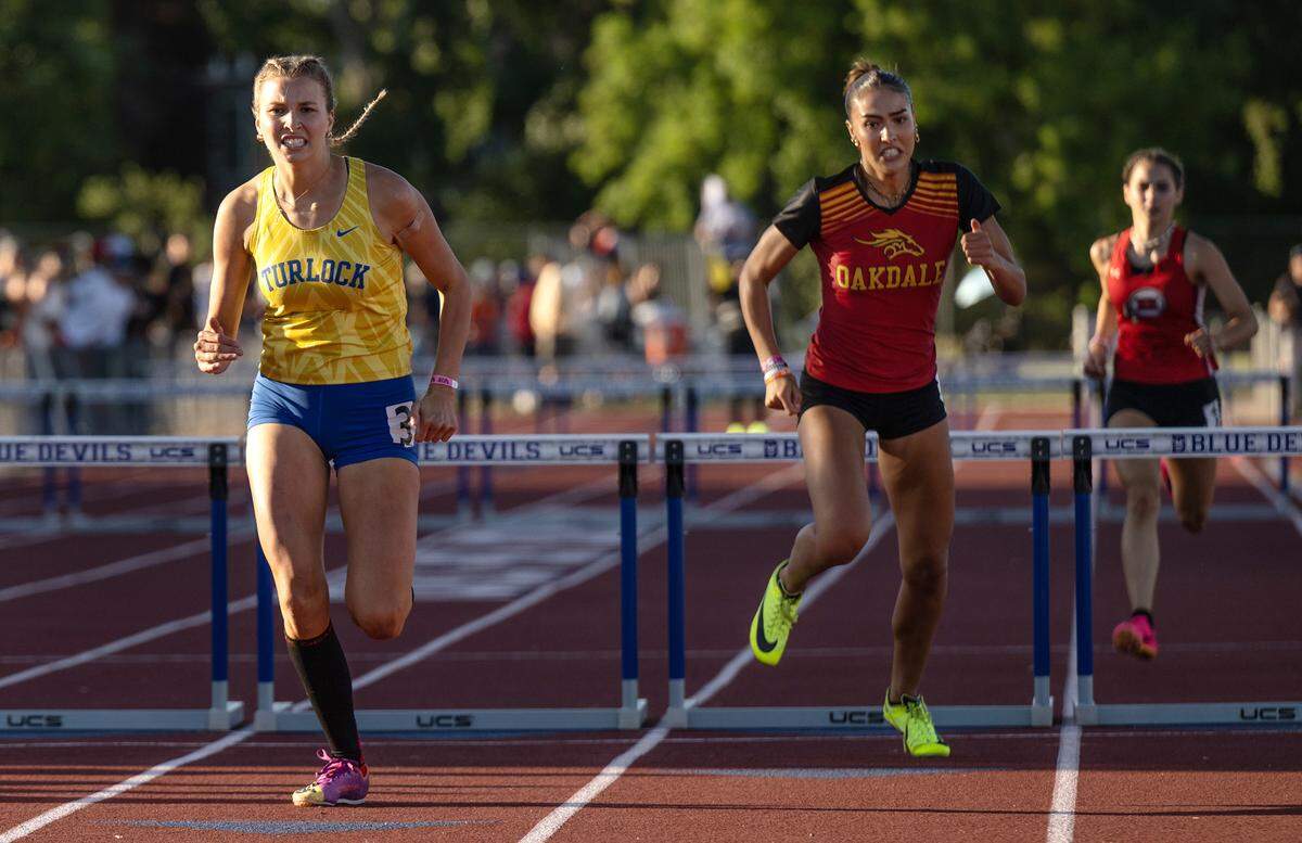 Turlock’s Ella Spaulding, left, and Oakdale’s Kylie Nunes battle for fourth place in the 300m hurdles during the CIF Sac-Joaquin Section Masters track finals at Davis High School in Davis, Calif., Saturday, May 20, 2023. Spaulding place fourth at 44.86 and Nunes fifth at 45.35.