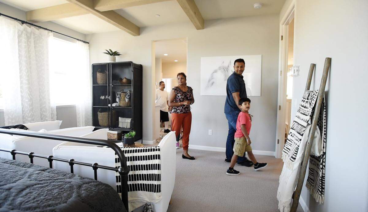 People look at a home at Icon at Inspiration, a Florsheim Home development, adjacent to the Vintage Faire Mall in Modesto, Calif., Saturday, July 20, 2019.